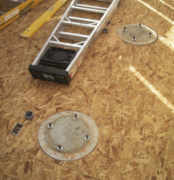 Observatory Framed - Pier Footings
The two pier footings are neatly in the floor.  The holes around the pier footings will be enlarged to prevent any touching between the floor and the pier.  The two-inch conduit is for data and goes to the warm room, and there is power at the base of each pier.
