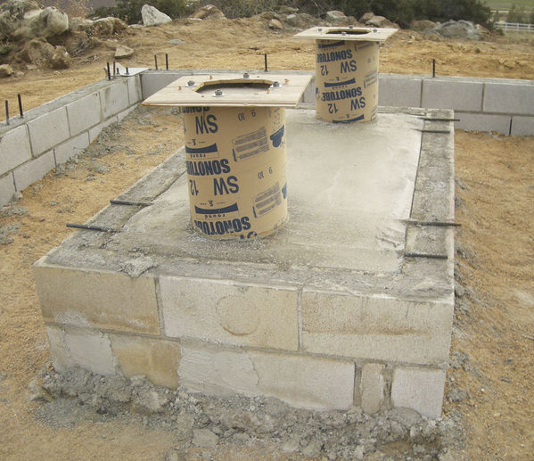 Pier Footings Set
The cement work on the pier footing is complete.  The piers are slightly offset from the walls and significantly offset from a north-south perspective.
