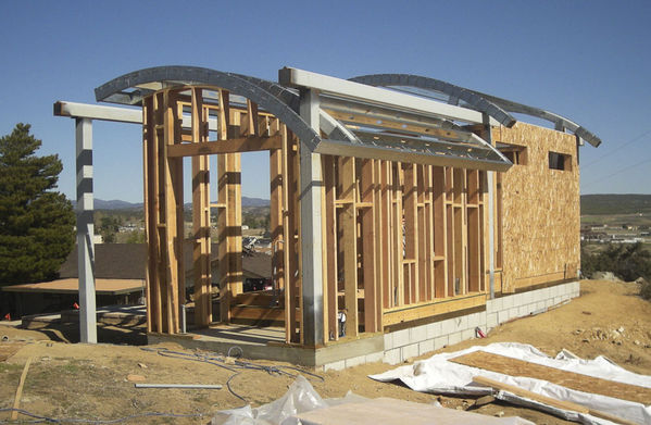 Roof Framed View to East
The warm room and equipment room are in the foreground.  The beam on top will carry the larger roof over the smaller part of the building.
