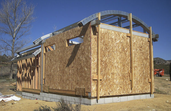Roof Framed View to Northwest
The curved rafters are bolted in place while the steel struts are attached.

